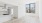 a living room with a window and a wood floor