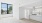 a living room with white walls and a wood floor