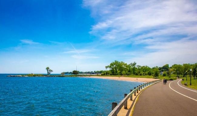 a road next to a body of water