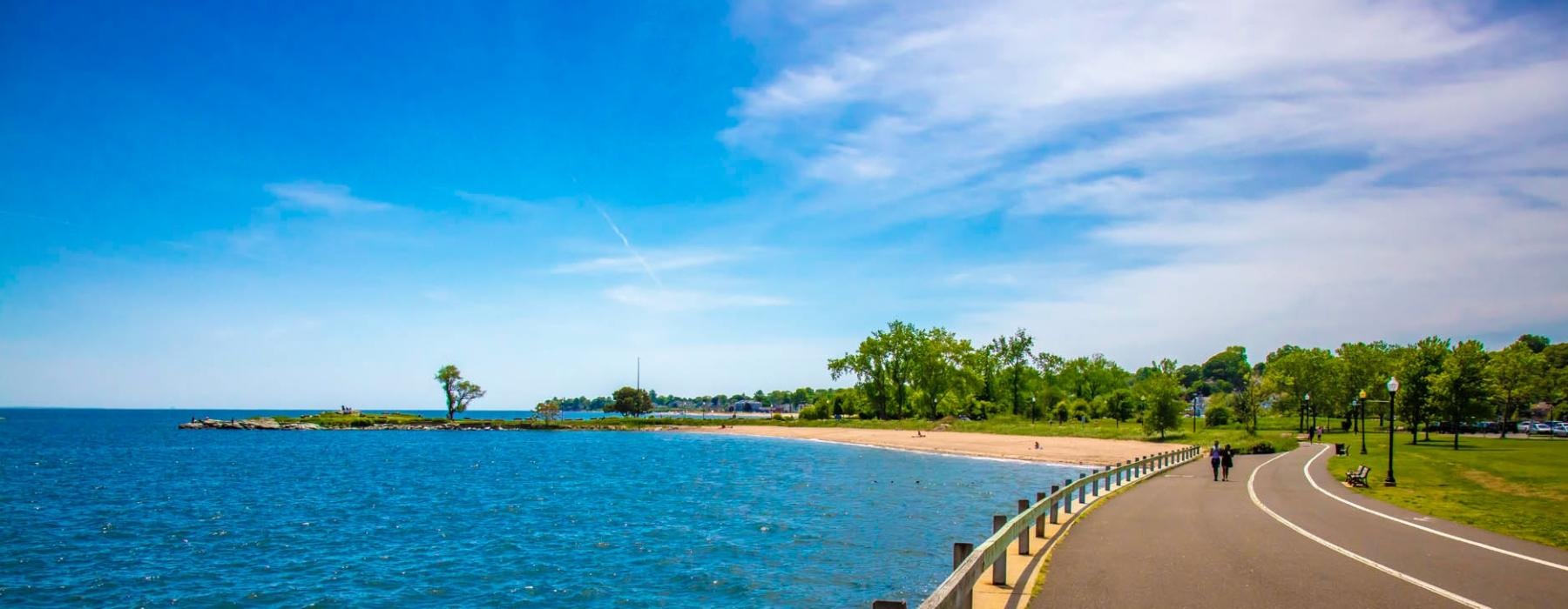 a road next to a body of water