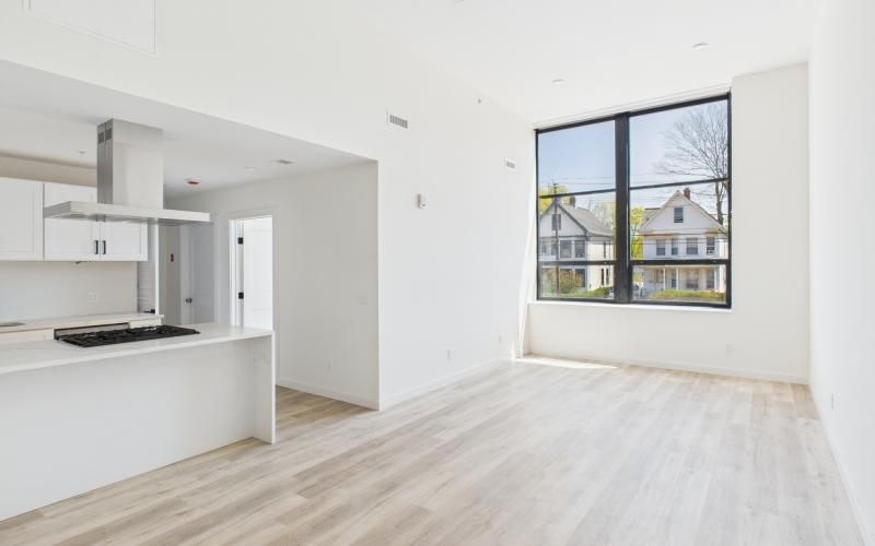 a living room with a window and a wood floor
